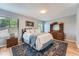 This bedroom features a plush queen bed, a large dresser, and natural light from two windows at 3752 S Helena Way, Aurora, CO 80013