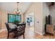 Elegant dining room with stylish chandelier, dark wood table, and view of kitchen at 3752 S Helena Way, Aurora, CO 80013