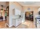 Open-concept kitchen with granite countertops, white cabinetry, and seamless flow to dining area at 3752 S Helena Way, Aurora, CO 80013
