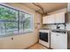Functional laundry room with white cabinets and modern washer and dryer units at 3752 S Helena Way, Aurora, CO 80013