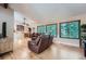 Bright living room with hardwood floors, large windows, and comfortable leather seating at 3752 S Helena Way, Aurora, CO 80013
