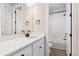 Modern bathroom featuring white marble countertops, black hardware, and a shower/tub combo at 1784 Morgan Dr, Erie, CO 80516