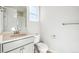 Clean bathroom with a shower, toilet, and vanity with stone countertops at 1784 Morgan Dr, Erie, CO 80516