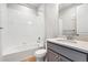 Neutral bathroom with tub and shower, granite counter vanity, and white tile at 1784 Morgan Dr, Erie, CO 80516