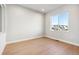 Bright bedroom with light hardwood floors and a large window with neighborhood views at 1784 Morgan Dr, Erie, CO 80516