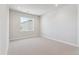Light-filled carpeted bedroom showcasing neutral tones and natural light at 1784 Morgan Dr, Erie, CO 80516