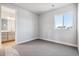 Neutral bedroom with neutral walls and carpet, and a window with view to neighborhood at 1784 Morgan Dr, Erie, CO 80516
