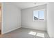 Bedroom featuring neutral walls and soft carpet, with natural light from a large window at 1784 Morgan Dr, Erie, CO 80516
