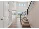 Open-concept entryway and staircase of a modern home featuring light wood floors and natural light at 1784 Morgan Dr, Erie, CO 80516