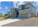 Attractive new home displaying stone accents, a gray two-car garage, and a concrete driveway at 1784 Morgan Dr, Erie, CO 80516