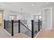 Upstairs hallway featuring dark-stained railing and neutral carpeting at 1784 Morgan Dr, Erie, CO 80516