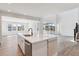 Modern kitchen island with white cabinets, stone countertops and a large sink with stainless steel faucet at 1784 Morgan Dr, Erie, CO 80516