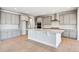 Open-concept kitchen featuring a large island, modern cabinets, and hardwood floors at 1784 Morgan Dr, Erie, CO 80516