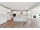 Open-concept kitchen showcasing a large center island and white cabinetry with stainless appliances at 1784 Morgan Dr, Erie, CO 80516