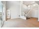 Open-concept living area with large staircase and sliding glass doors at 1784 Morgan Dr, Erie, CO 80516