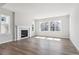 Bright living room featuring a fireplace, hardwood floors, and large windows with plenty of natural light at 1784 Morgan Dr, Erie, CO 80516