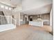 Open floor plan showcases the living room, staircase, and kitchen with an island at 1784 Morgan Dr, Erie, CO 80516