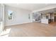 Spacious open-concept living room with light hardwood floors connecting to the kitchen at 1784 Morgan Dr, Erie, CO 80516
