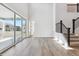 Open floor plan featuring hardwood floors, stairs, and sliding glass doors to the patio at 1784 Morgan Dr, Erie, CO 80516