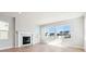 Bright living room featuring a fireplace, large windows, and hardwood flooring at 1784 Morgan Dr, Erie, CO 80516