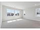 A spacious carpeted room is filled with natural light from multiple windows at 1784 Morgan Dr, Erie, CO 80516