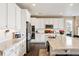 Bright kitchen featuring white cabinets, granite countertops, stainless steel appliances, and a central island at 6196 Leilani Dr, Castle Rock, CO 80108