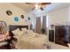 Comfortable bedroom with a ceiling fan, records, and a cozy bed at 409 N Garden Ct, Platteville, CO 80651