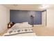 Cozy bedroom featuring carpeted floors, minimal furnishings, and a blue accent wall at 409 N Garden Ct, Platteville, CO 80651
