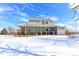 Back yard with a covered porch and snow on the ground at 409 N Garden Ct, Platteville, CO 80651
