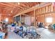 Spacious garage featuring wooden beam ceilings, a concrete floor, and an array of tools and equipment at 409 N Garden Ct, Platteville, CO 80651