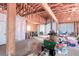 Spacious garage with exposed beams, concrete floor, and multiple garage doors for convenient access at 409 N Garden Ct, Platteville, CO 80651