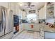 Well-lit kitchen with white cabinets, granite countertops, stainless steel appliances, and decorative accents at 409 N Garden Ct, Platteville, CO 80651