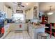Charming kitchen featuring white cabinets, granite countertops, decorative shelves, and modern appliances at 409 N Garden Ct, Platteville, CO 80651