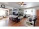 Spacious living room with hardwood floors, fireplace, bay window, and comfortable seating at 409 N Garden Ct, Platteville, CO 80651