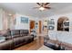 Spacious living room with hardwood floors and comfortable seating adjacent to dining and kitchen areas at 409 N Garden Ct, Platteville, CO 80651
