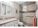 Stylish bathroom features an upgraded tile shower and granite counters at 1563 S Trenton Ct, Denver, CO 80231