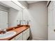 Bathroom featuring single vanity and a framed mirror at 1563 S Trenton Ct, Denver, CO 80231