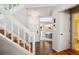 Bright entryway with stairs leading to the upper level, offering a glimpse into the dining area at 1563 S Trenton Ct, Denver, CO 80231