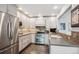 Modern kitchen with stainless steel appliances, ample counter space, and updated fixtures at 1563 S Trenton Ct, Denver, CO 80231
