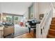 Open living room featuring hardwood floors, a fireplace, and a grand piano at 1563 S Trenton Ct, Denver, CO 80231