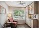 Sitting area with a large window, tile flooring, and built-in cabinets at 1563 S Trenton Ct, Denver, CO 80231