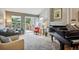 Open living room featuring hardwood floors, a fireplace, and a grand piano at 1563 S Trenton Ct, Denver, CO 80231