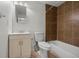 Functional bathroom features a vanity with storage, a toilet, and a tiled shower-tub combination at 5167 Sable St, Denver, CO 80239