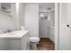 Bathroom with a single sink vanity, toilet and combined washer/dryer at 5167 Sable St, Denver, CO 80239