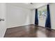 Bedroom with hardwood floors, white walls, and large window providing natural light at 5167 Sable St, Denver, CO 80239