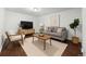 Cozy living room with modern furniture, a stylish rug, and a large television at 5167 Sable St, Denver, CO 80239