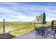 Large outdoor patio and yard with an outdoor dining set and views of the surrounding farmlands at 18553 County Road 5, Berthoud, CO 80513