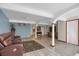 Finished basement offers living space with a beautiful rug, stylish columns, and modern gray flooring at 18553 County Road 5, Berthoud, CO 80513