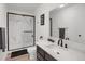 Modern bathroom featuring a glass-enclosed shower and stylish marble countertops at 18553 County Road 5, Berthoud, CO 80513