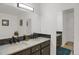 Updated bathroom with double vanity, framed mirrors, and sleek, modern fixtures at 18553 County Road 5, Berthoud, CO 80513